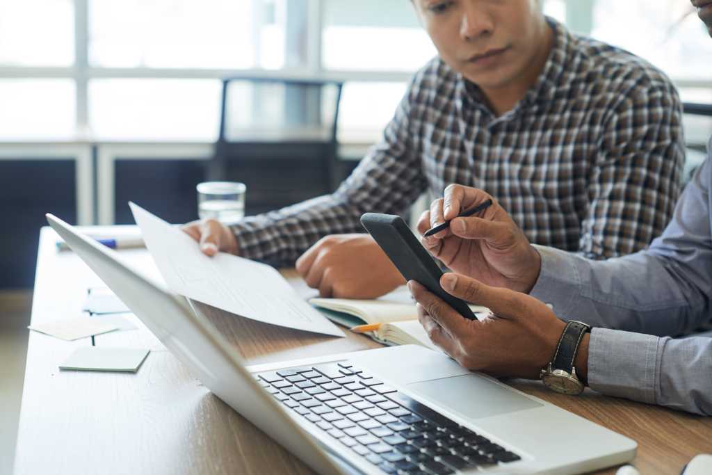 shutterstock 1192989865 developer with smartphone and stylus testing application interface